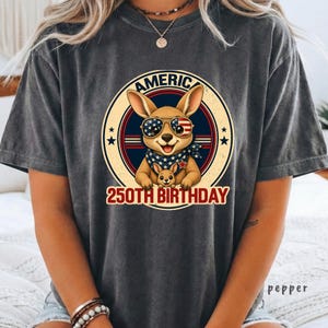 Cute patriotic kangaroo wearing American flag sunglasses shirt, America 250 shirt, funny animal tee, patriotic shirt, retro USA shirt, 4th of July shirt, vintage Americana animal graphic tee, USA 250 anniversary apparel, independence day shirt, animal graphic tee, summer patriotic outfit, funny patriotic animal shirt, freedom celebration shirt, fourth of july tee, cute kangaroo lover gift.