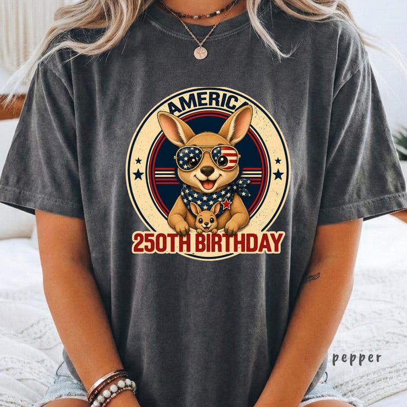 Cute patriotic kangaroo wearing American flag sunglasses shirt, America 250 shirt, funny animal tee, patriotic shirt, retro USA shirt, 4th of July shirt, vintage Americana animal graphic tee, USA 250 anniversary apparel, independence day shirt, animal graphic tee, summer patriotic outfit, funny patriotic animal shirt, freedom celebration shirt, fourth of july tee, cute kangaroo lover gift.