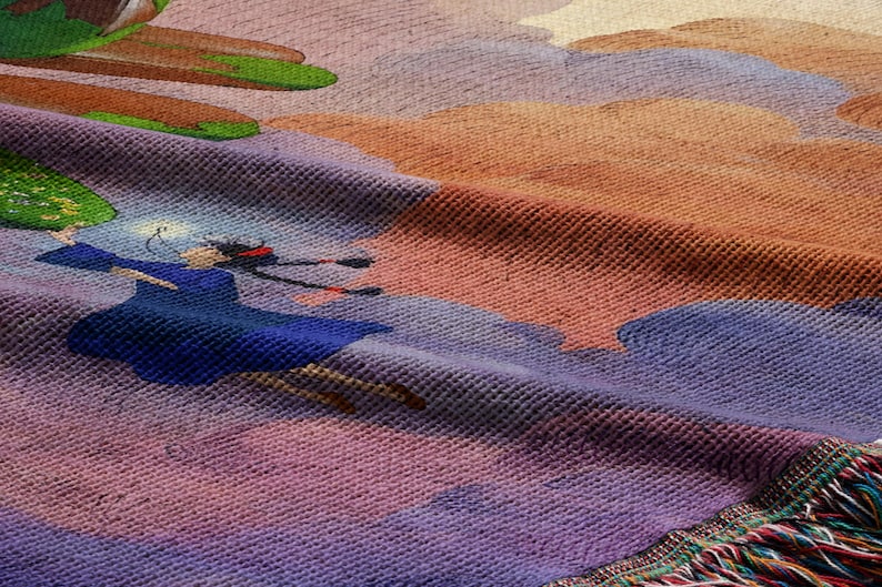 The image is a close-up of a colorful textile with a painting of a woman in a blue dress and hat.