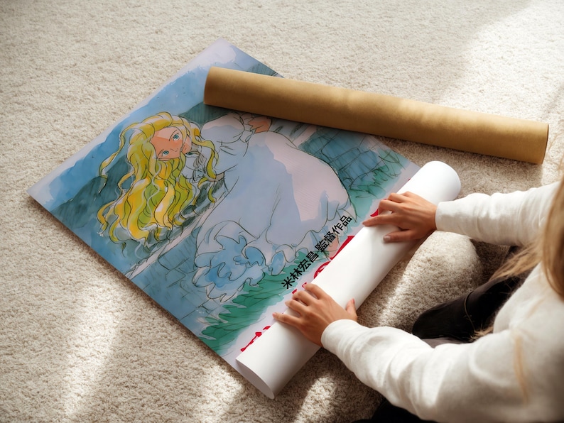 A person is sitting on the floor and placing a rolled-up poster under a drawing of a woman with long blonde hair.
