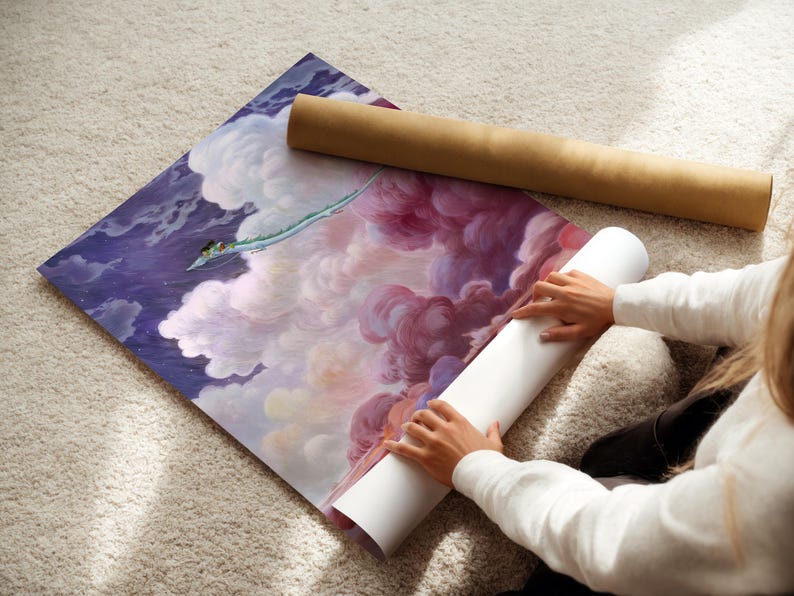 A person is unfolding a large piece of paper with a painting of a colorful, cloud-filled sky on it, which appears to be a large poster or canvas.