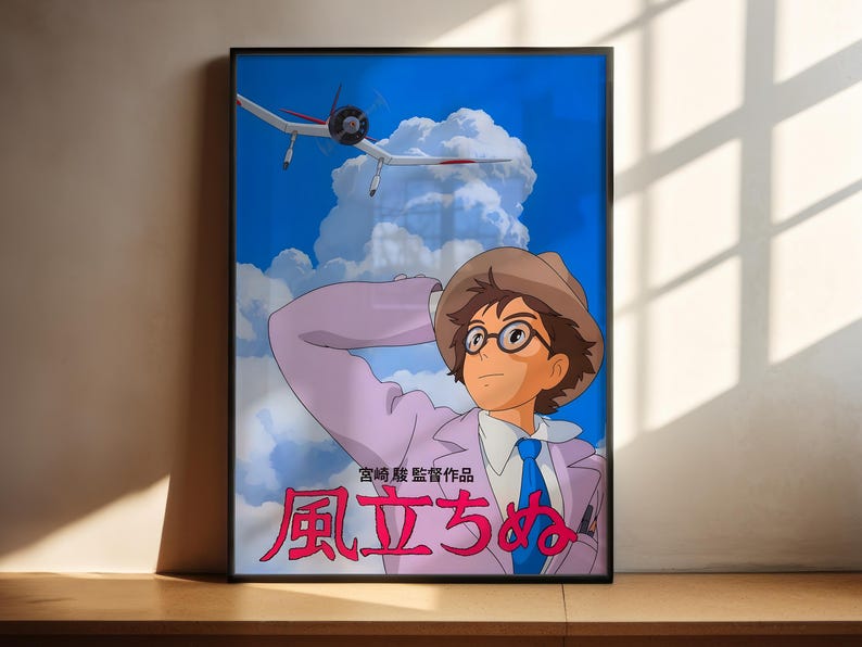 The image is a framed poster featuring an illustration of a young man with glasses and a hat, who appears to be a character from an anime or manga series. The poster also includes text in Japanese, which translates to "The image depicts a young man with glasses and a hat, who is a character from an anime or manga series."