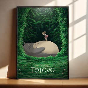 The image is a poster featuring a scene from the animated film "My Neighbor Totoro", depicting a young girl standing on a large, gray cat-like creature in a lush, green forest.