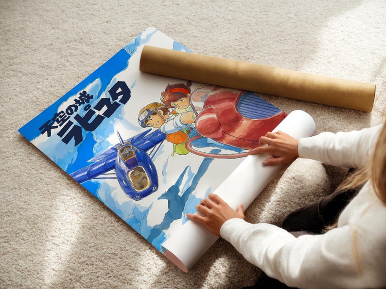 A person is holding a roll of paper and a poster featuring an illustration of a blue airplane and two cartoon characters.