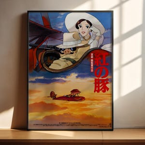 The image is a poster featuring an animated scene with a woman and a red airplane flying in the sky. The poster has a predominantly blue and orange color scheme, with the woman wearing a white hat and the airplane having a red tail. The poster also includes Japanese text, which translates to "The image depicts a red airplane flying in the sky".
