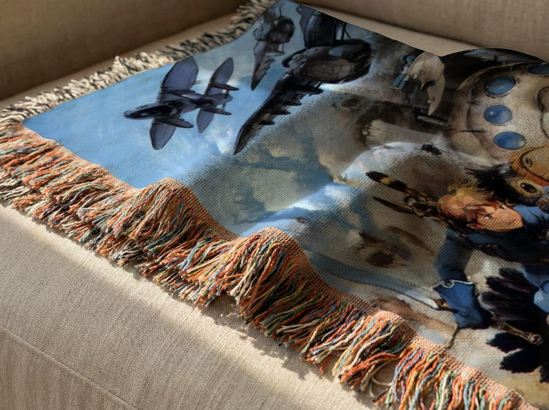 a close-up view of a colorful blanket or throw with a unique design, including various objects such as airplanes, a person, and other abstract shapes.