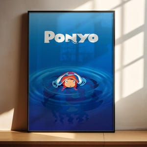 A framed poster featuring the character Ponyo from the animated film "Ponyo". Ponyo is shown swimming in a blue body of water, surrounded by bubbles.
