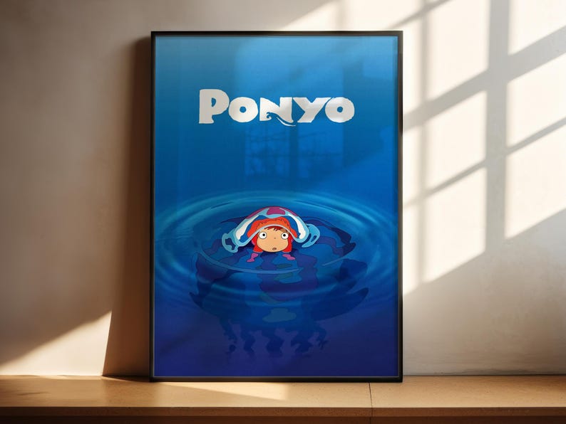 A framed poster featuring the character Ponyo from the animated film "Ponyo". Ponyo is shown swimming in a blue body of water, surrounded by bubbles.
