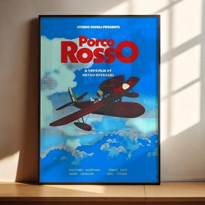 A poster for the 1995 film "Porco Rosso" by Hayao Miyazaki, featuring an illustration of a red airplane flying through a blue sky with clouds.
