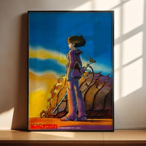 The image is a framed poster featuring an illustration of a woman standing in a desert landscape, holding a sword and accompanied by a large, spiky creature.