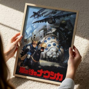 A person is holding a framed poster featuring an illustration of a character riding a horse, with various fantastical elements and creatures in the background.