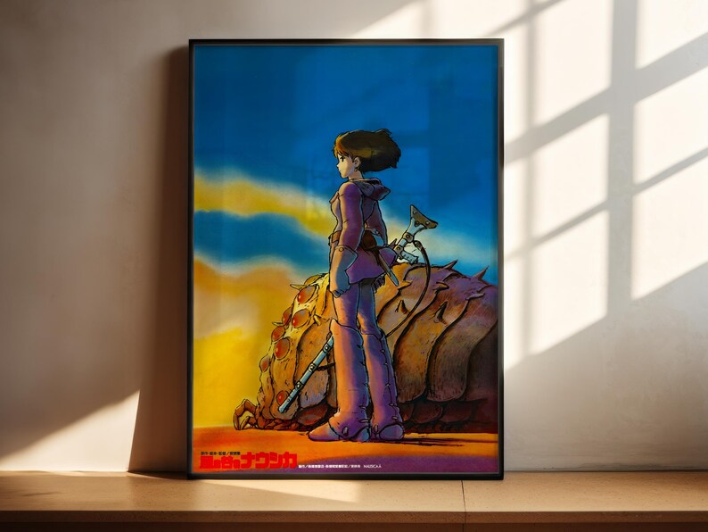 The image is a framed poster featuring an illustration of a woman standing in a desert landscape, holding a sword and accompanied by a large, spiky creature.