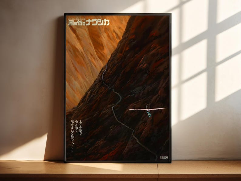 The image is a framed poster featuring an artistic depiction of a mountain landscape with a winding path leading up to a cliff.