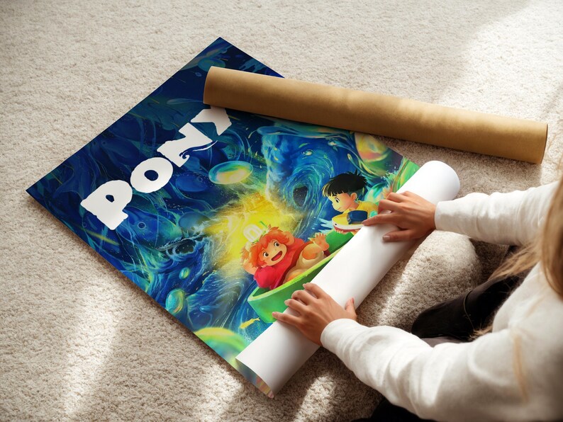 A person is holding a roll of paper and a poster featuring colorful cartoon characters, including Pony, on a carpeted floor.