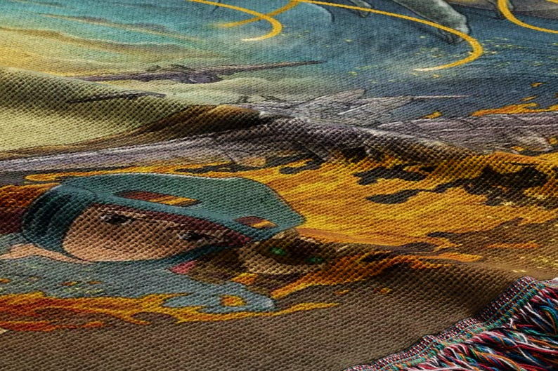 The image is a close-up of a colorful, textured fabric with a detailed, artistic design featuring a character wearing a helmet and surrounded by a fiery, fantastical landscape.