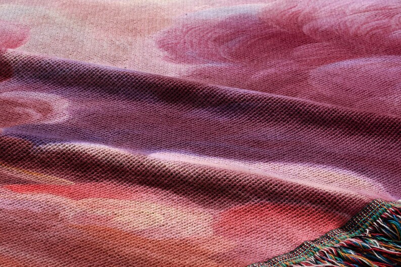 The image is a close-up of a fabric with a floral pattern, featuring a mix of pink, purple, and orange colors.