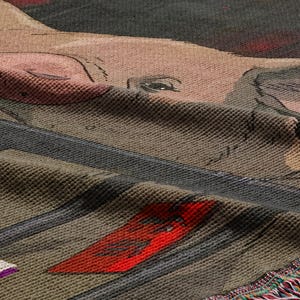 a close-up view of a textured fabric with a pig design, including a pink snout and large ears.