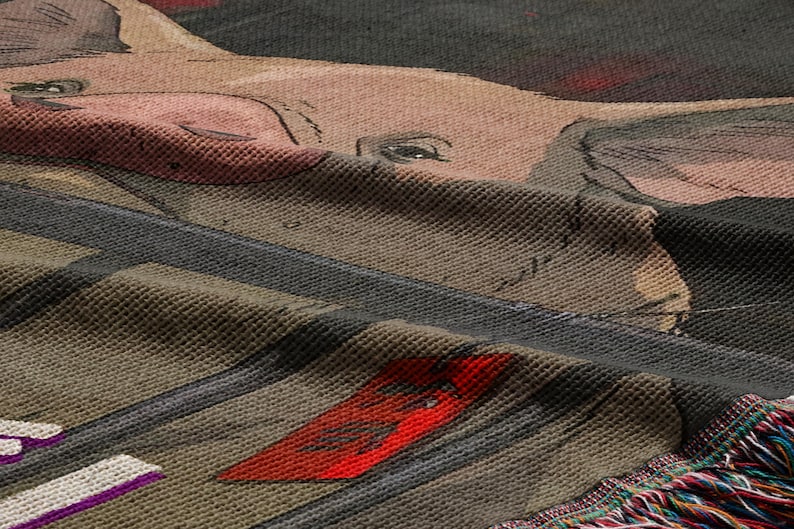 a close-up view of a textured fabric with a pig design, including a pink snout and large ears.