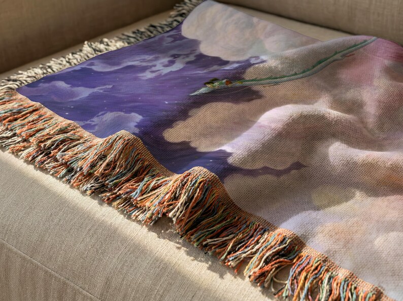 a close-up view of a colorful blanket with a dragon design on it, resting on a beige couch.