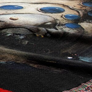 a close-up view of a textured fabric with a striking pattern of blue circles and a dark background.