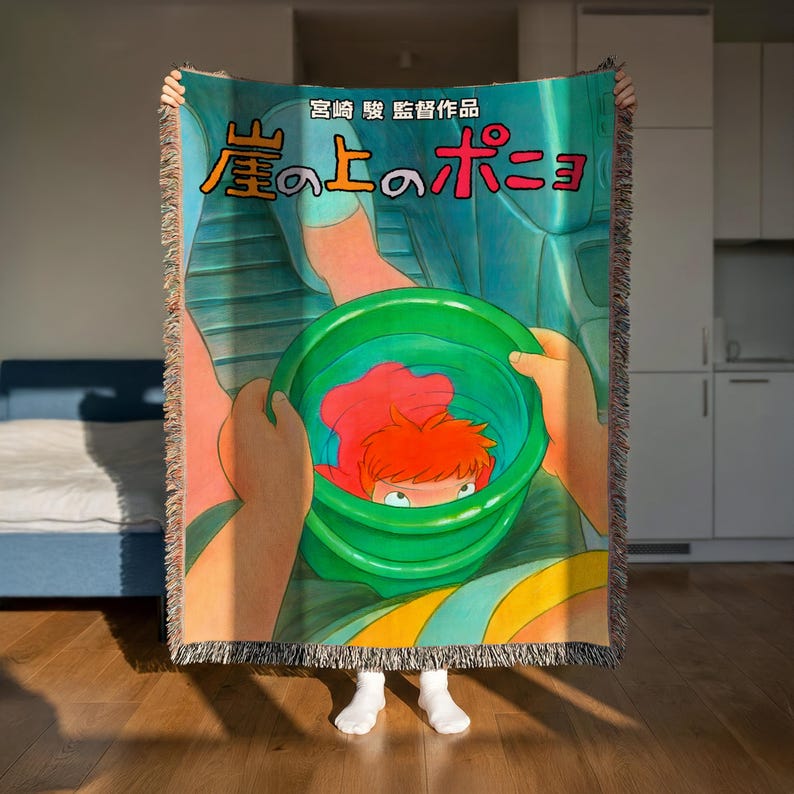 A person is holding up a colorful blanket with an illustration of a character from the animated film "My Little Pony".