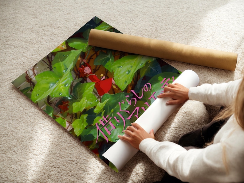 A person is holding a roll of paper and placing it on a colorful poster with a green background and a red character.