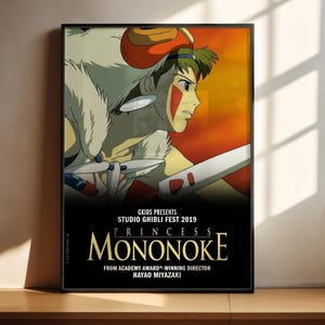 A poster for the Studio Ghibli film "Princess Mononoke" featuring an animated character with a sword and a large white creature.