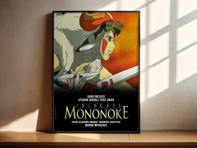 A poster for the Studio Ghibli film "Princess Mononoke" featuring an animated character with a sword and a large white creature.