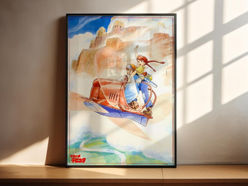 The image is a framed poster featuring an illustration of two people riding a vehicle, possibly a car or a boat, through a fantastical landscape with mountains and clouds in the background.