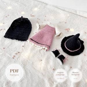 May include: A crochet set including a black hat, a pink dress with white long sleeves and a ruffled hem, a black pointed hat with a pink band, and a pair of black and white booties. The image includes text reading PDF Pattern, English Language (US Terms), and Human Designed (no AI).
