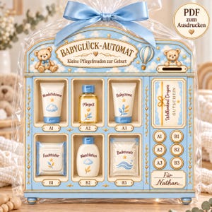 May include: A light blue vending machine-style gift set for babies, wrapped in clear plastic with a blue ribbon. It features illustrations of teddy bears, a hot air balloon, and labels for baby care products like cream, oil, and lotion, with a personalized section for Nathan.