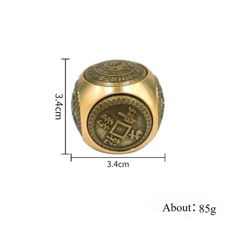 May include: A gold-colored, cube-shaped object with an antique coin design on its faces. The object measures 1.3 inches on each side and weighs approximately 3 ounces. The cube features detailed engravings and a vintage aesthetic.