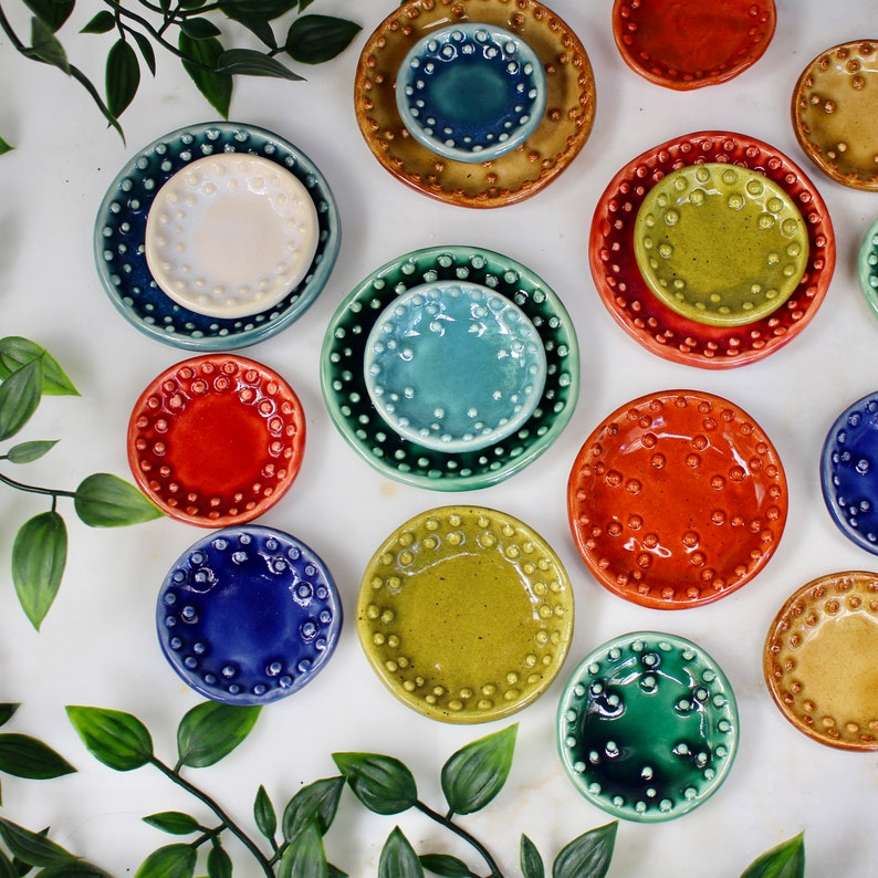 May include: A set of three ceramic vases in varying heights. The tallest vase is approximately 10 inches high, the medium vase is 8 inches, and the smallest is 6 inches. Each vase has a matte white finish and a minimalist design.