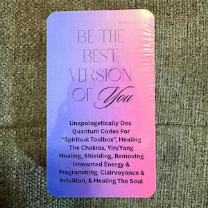 May include: A rectangular card with a gradient of purple to pink, featuring the text "BE THE BEST VERSION OF You." Additional text describes the card's purpose: Quantum Codes for healing, intuition, and soul healing. Volume #2 is printed at the top.