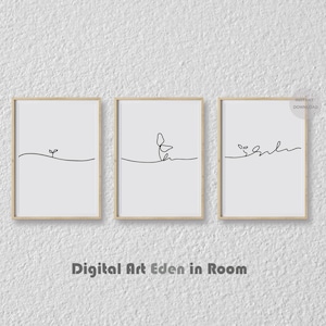 Op de afbeelding: Drie minimalistische kunstprints met lijst. Elke print toont een zwarte lijntekening van een plant op een witte achtergrond. De lijsten zijn licht van kleur. De tekst "Digital Art Eden in Room" staat onderaan.