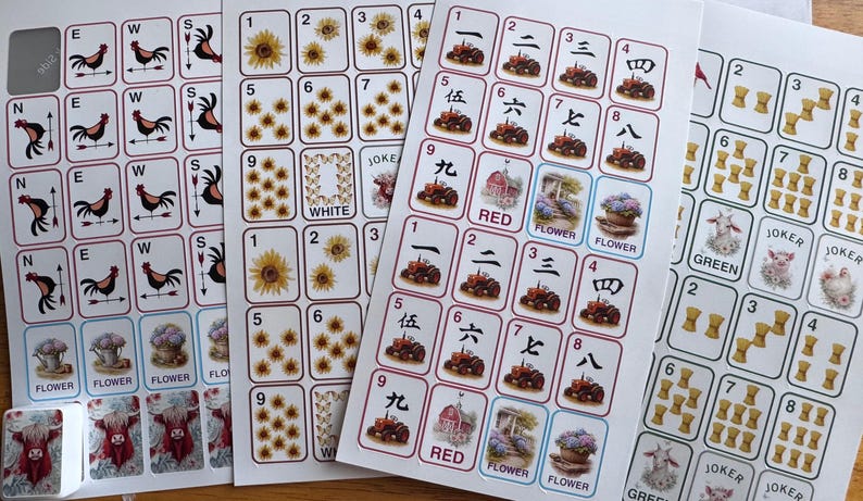 May include: Sheets of stickers featuring various designs, including roosters, sunflowers, and Chinese characters. The stickers have a white background with red, blue, and green accents. Some stickers have the words "RED", "FLOWER", and "WHITE".