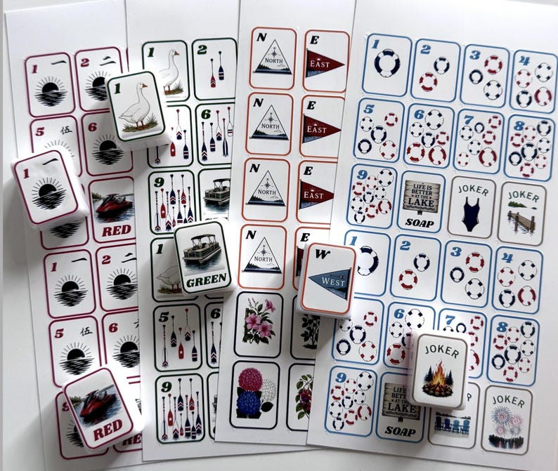 May include: A collection of nautical-themed stickers and game cards. The cards feature images of boats, compasses, and life preservers. Some cards have the words "RED" and "GREEN". The stickers have images of geese, flowers, and a campfire.