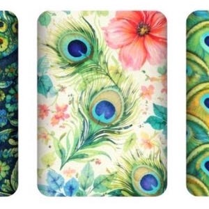 May include: Three rectangular designs with floral and peacock feather patterns. The first features a dark blue floral design with green and orange accents. The second has peacock feathers and a pink flower on a white background. The third has a pattern of peacock feathers.