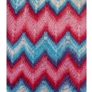 May include: A rectangular knitted fabric with a chevron pattern. The design features alternating bands of red, pink, light blue, and white. The fabric has a textured appearance, suggesting a soft and comfortable material.