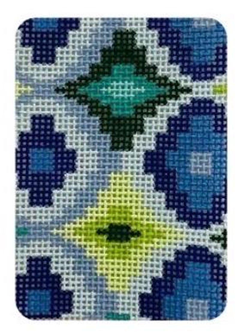 May include: A rectangular needlepoint design featuring a repeating geometric pattern. The pattern includes diamond and floral shapes in shades of blue, green, and yellow on a light blue background. The needlepoint has a textured appearance.