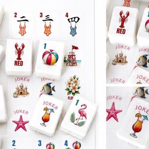 May include: A collection of white Mahjong tiles featuring colorful beach-themed illustrations. The tiles display images of swimsuits, a lobster, a beach ball, a turtle, a flamingo, and a cocktail. Some tiles have the word "JOKER" on them.
