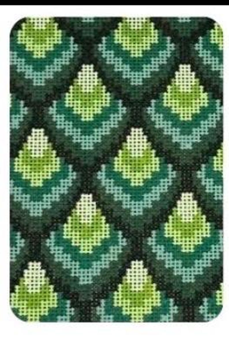 May include: A close-up of a needlepoint canvas with a repeating geometric pattern. The design features diamond shapes in shades of green, teal, and dark green, creating a textured, handcrafted appearance. The pattern is symmetrical and fills the entire frame.