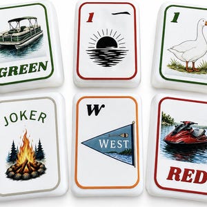 May include: Six white ceramic tiles with colorful illustrations and text. The tiles feature images of a boat, a sunset, a goose, a campfire, a nautical flag, and a jet ski. The text includes "GREEN", "1", "JOKER", "W WEST", and "RED".