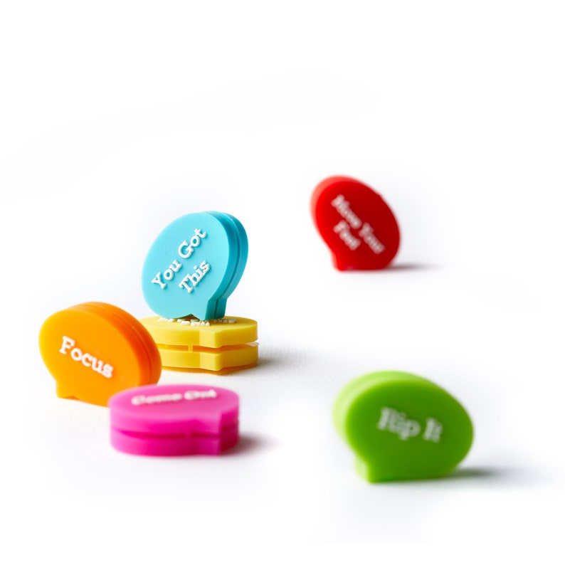 May include: Five colorful motivational speech bubble-shaped clips. The blue clip says "You Got This", the orange clip says "Focus", the pink clip says "Game On", the green clip says "Flip It", and the red clip says "Know Your Fuel".