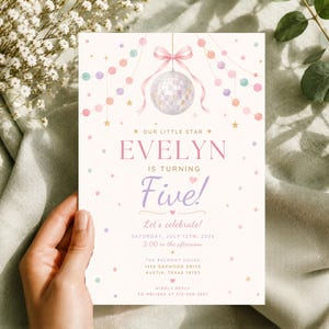 May include: A birthday invitation card featuring a disco ball hanging from a pink ribbon, surrounded by pastel-colored garlands and stars. The text reads: Our Little Star Evelyn is turning Five! Let's celebrate! Saturday, July 12th, 2026, 2:00 PM.