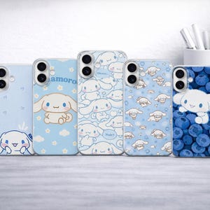 May include: Five light blue phone cases with cartoon character designs. The cases feature a character with long ears, a pattern of the same character, and a case with blueberries. One case has the word "amoro".