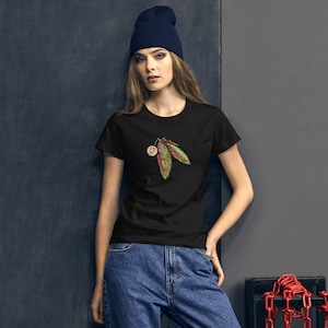 May include: A black t-shirt with a green and pink leaf design. The design features a small pink flower and two leaves.