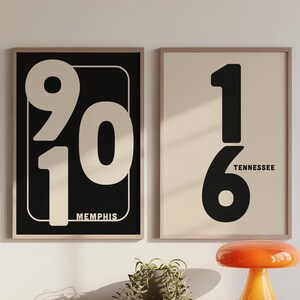 May include: Two framed art prints with large numbers. One print has the numbers 901 and the word Memphis. The other print has the numbers 16 and the word Tennessee. The prints are in wooden frames.