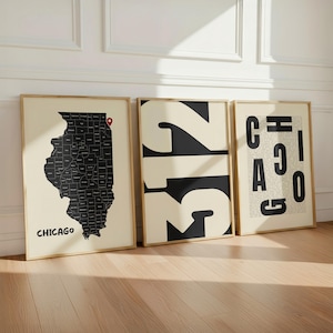 May include: Three framed wall art prints featuring Chicago themes. The left print shows a black Illinois map with a red location pin and the text CHICAGO. The center print displays the large black numbers 312. The right print features the text CHICAGO.