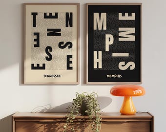 May include: Two framed art prints. One features the word "TENNESSEE" in large black letters over a beige background, with the word "Tennessee" below. The other print says "MEMPHIS" in large white letters over a black background, with "Memphis" below.